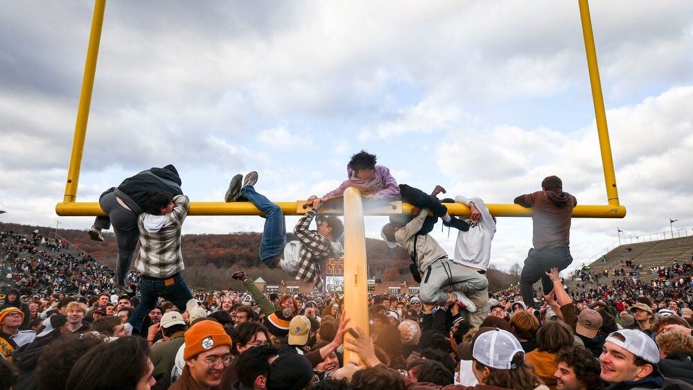 lehigh students climbing on and hanging from goal post at goodman stadium 11/23/24