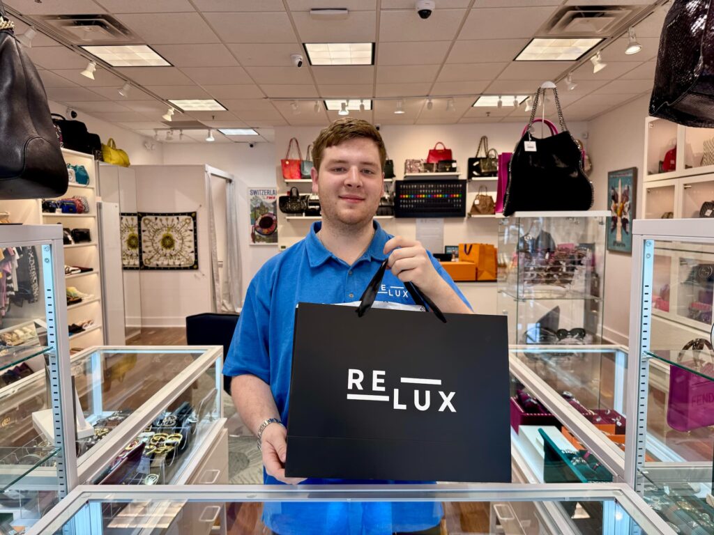 relux saucon valley founder coleman nichelson poses for a photo inside of the luxury consignment shop